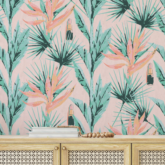 printed grasscloth wallpaper light pink based allover floral print with light pink and orange birds of paradise floral paired with shades of green palm leaves with added light pink lipstick tubes scattered throughout the print. Natural Textured Eco-Friendly Non-toxic High-quality Sustainable practices Sustainability Interior Design botanical medspa beauty salon custom wall cover garden paperweave paper weave