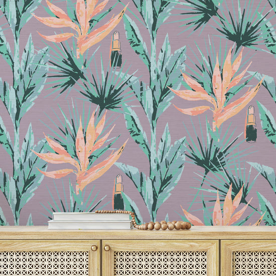 light purple based allover floral print with light pink and orange birds of paradise floral paired with shades of green palm leaves with added light pink lipstick tubes scattered throughout the print Grasscloth Natural Textured Eco-Friendly Non-toxic High-quality  Sustainable practices Sustainability Interior Design Wall covering bold vertical stripe botanical flowers garden tropical jungle beauty salon medspa makeup