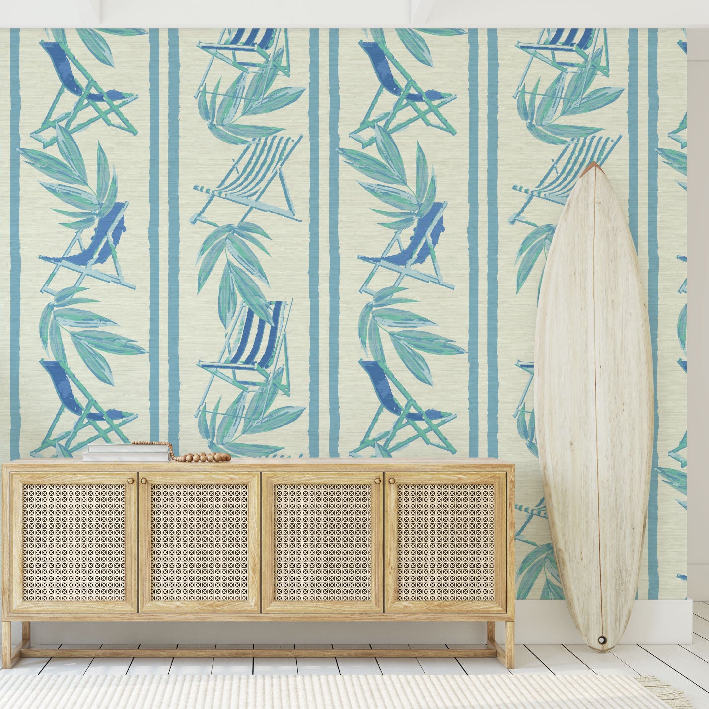 vertical linear grasscloth wallpaper print with a beachy design of blue leaves and stripes paired with shades of blue beach chairs arranged in a vertical oversized stripe Grasscloth Natural Textured Eco-Friendly Non-toxic High-quality Sustainable practices Sustainability Interior Design Wall covering bold Seaside Coastal Seashore Waterfront Vacation home styling Retreat Relaxed beach vibes Beach cottage Shoreline Oceanfront Nautical