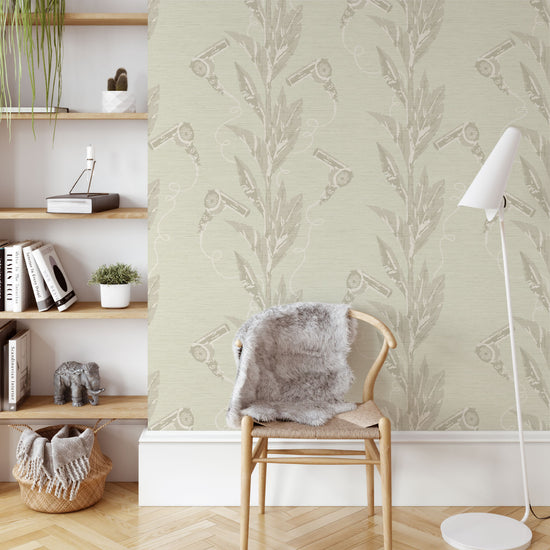 tan based printed grasscloth wallpaper with tonal colored leaf vertical stripes paired with tonal colored hair blow dryers popping out of them.