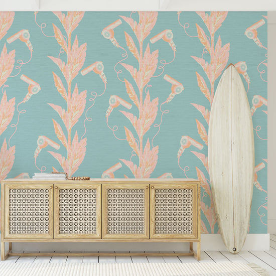 light blue based printed grasscloth wallpaper with light pink and orange palm leaf vertical stripes paired with hair blow dryers popping out of them.