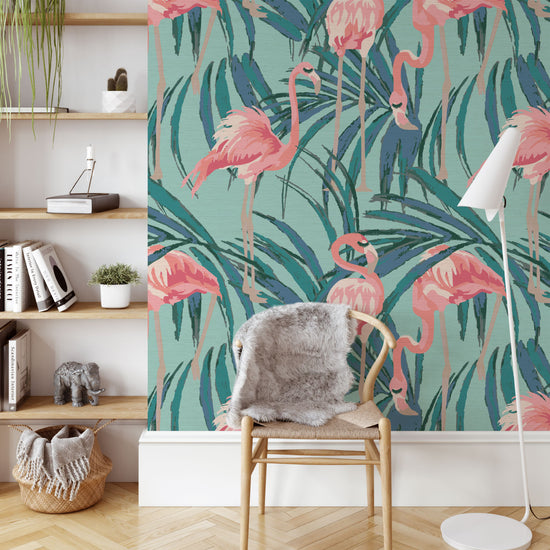 dusty teal printed grasscloth wallpaper with oversized palm leaves layered with extra large flamingos in shades of pink with unexpected luscious eyelashes