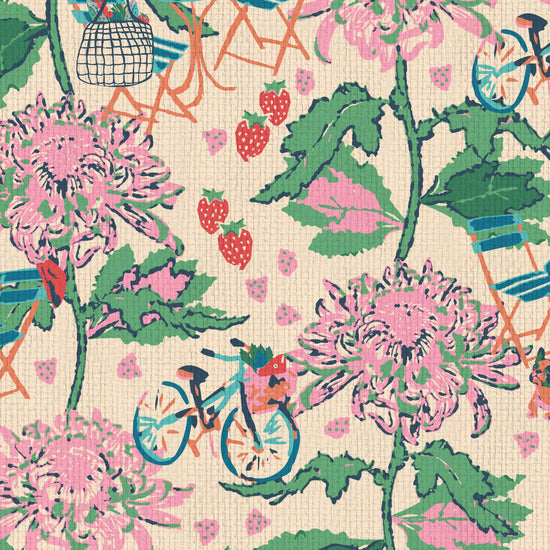 Printed grasscloth wallpaper inspired by the french market, off white base with linear pink florals arranged in vertical stripes.  filled in between are tiny scenes of bicycles with a basket full of market groceries, a bistro set of furniture featuring a bottle of pellegrino and glasses; mixed fruit scattered throughout the print. food fruit bistro chair table paperweave