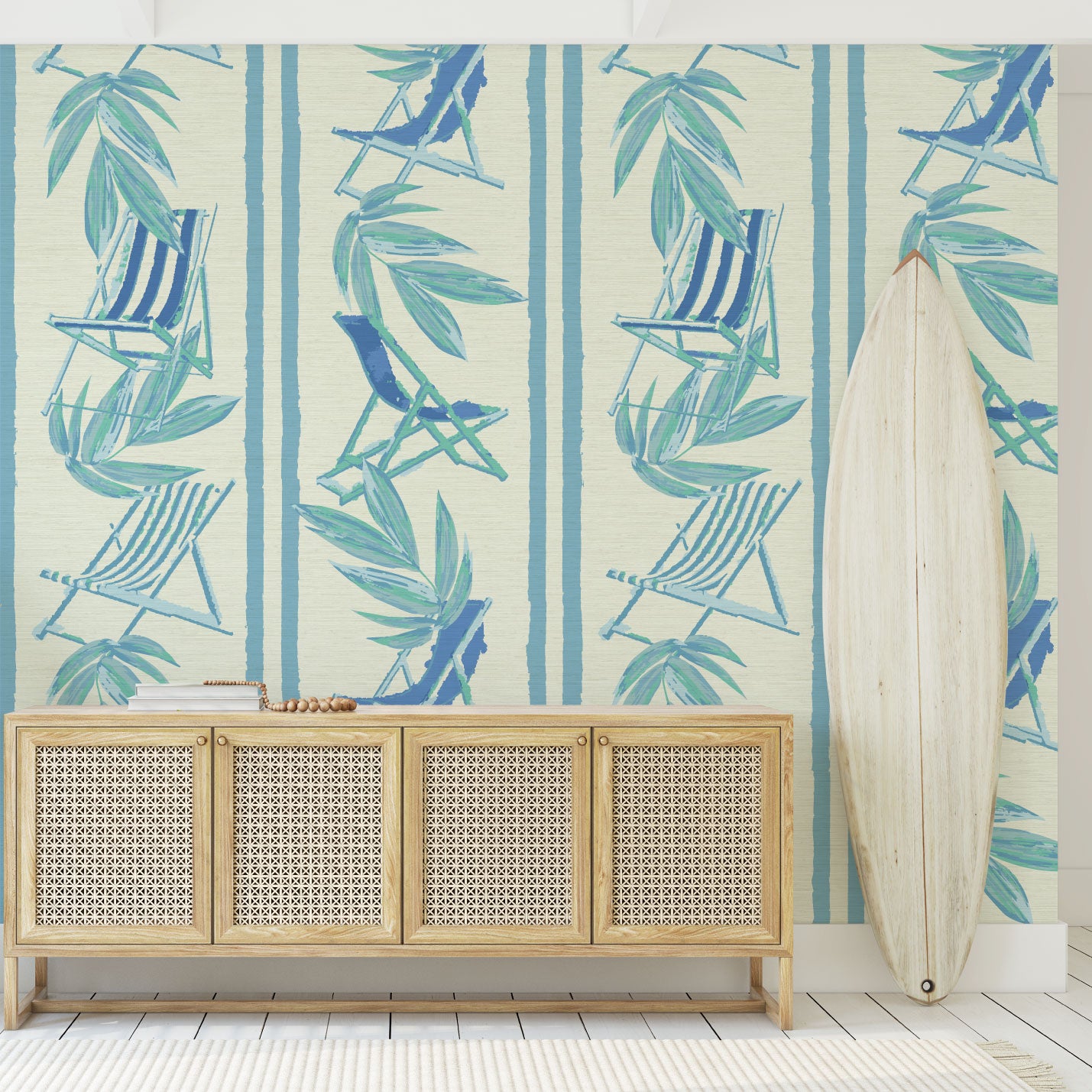 Load image into Gallery viewer, Beach house entrance with surfboard that has vertical linear grasscloth wallpaper print with a beachy design of blue leaves and stripes paired with shades of blue beach chairs arranged in a vertical oversized stripe.
