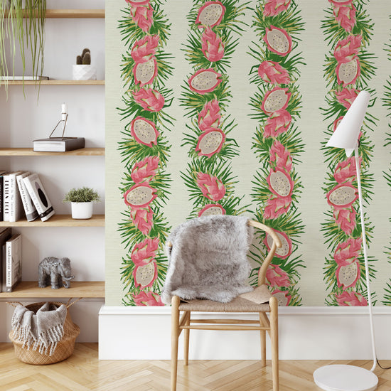 Printed grasscloth wallpaper on off-white base with linear vertical stripes of palm leaves and bright pink passion fruits