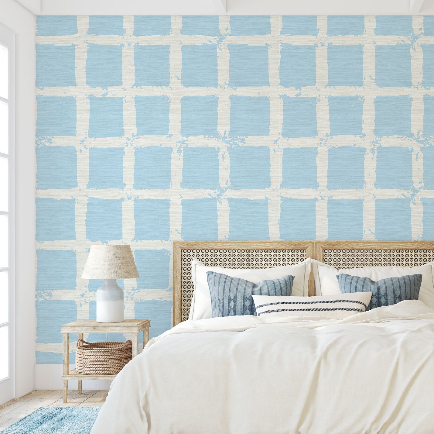 Bedroom with grasscloth wallpaper in hand painted square pattern emulating window panes in an oversized plaid layout with a french blue base on cream print