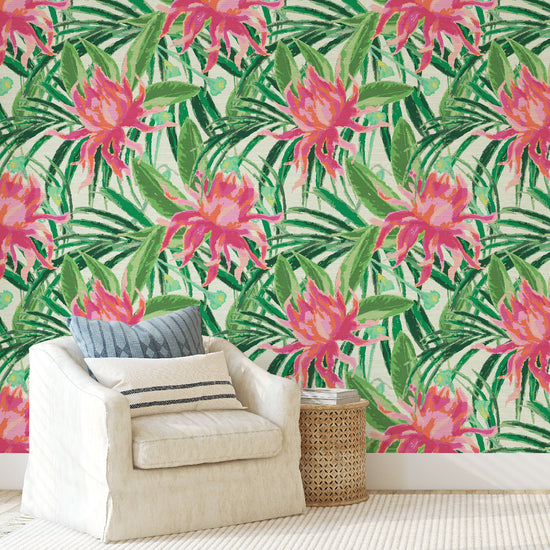 grasscloth wallpaper with cream based featuring oversized painterly tropical flowers and palm leafs in striking shades of pink and orange and leafs in shades of bright green Natural Textured Eco-Friendly Non-toxic High-quality Sustainable Interior Design Bold Custom Tailor-made Retro chic Tropical Jungle Coastal preppy Garden Seaside Coastal Seashore Waterfront Vacation home styling Retreat Relaxed beach vibes Beach cottage Shoreline Oceanfront botanical palm leaf living room